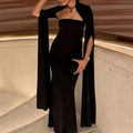 Detail of elegant black strapless evening dress with long fringe shawl sleeves on a model - 3XL / Black