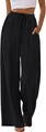 Détail du pantalon large noir montrant la taille à cordon et des poches latérales - S / Bas / Noir