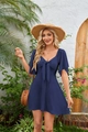 Detail of navy blue V-neck dress with bow tie waist and flutter sleeves in a garden - Navy Blue