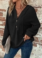 Detail of black waffle knit hoodie showing V-neckline with wood buttons and drawstring hood - S / Black