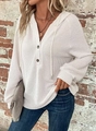 Close-up of waffle knit texture and button V-neck detail on white long sleeve hoodie - White