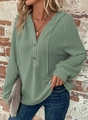 Detail of waffle knit fabric on sage green hoodie with V-neck button and drawstring - Green