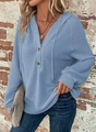 Detail of blue waffle knit texture with V-neckline and wooden buttons on a casual hoodie - Light Blue