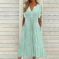 Close-up of mint green eyelet dress featuring V-neck buttons and tied knot sleeve detail - Light Green
