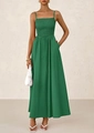 Macro detail of the smocked chest and delicate spaghetti straps on this green maxi dress - Dark Green
