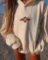 Close-up of brown hibiscus flower embroidery on cream-colored oversized drawstring hoodie - S / Off White