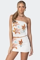 Detailed close-up of floral print mini skirt and tube top set with lilies and butterflies - S / White