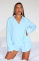 Close-up of light blue long-sleeved buttoned pajama top with soft fabric texture and pocket - XL / Top And Bottom / Blue