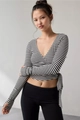 Detail of black and white striped crop top with V-neck and thumbhole sleeves - S / Striped