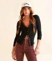 Close-up of black ribbed knit cardigan featuring metallic buttons and slim-fit texture - Black