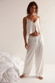 Detailed view of white satin pajama set with delicate lace trim on hem and V-neckline - S / White