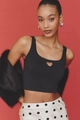 Detailed view of black cropped tank top featuring heart-shaped cutout on red background - S / Black