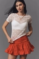 Detail of white sheer mesh top with bow pattern and orange ruffled skirt texture - S / White