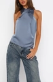 Detail of elegant grey-blue satin halter top showing smooth texture and draped neckline - Blue
