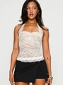 Close-up of white floral lace texture and eyelash lace trim on a halter neck top - S / Tops / White