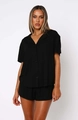 Close-up of black short-sleeved pajama set featuring lapel collar and button-down detail - S / Black