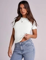 Detail of white rib-knit T-shirt showing ruffled lettuce edge hem and crew neck design - White