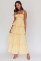 Detail of floral print tiered dress featuring bow accents and elegant layered skirt - S / Yellow