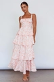 Detail view of the layered tiered hem and floral print on white sleeveless maxi dress - Orange