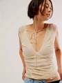 Detail of floral lace texture on white V-neck top with delicate tie-up front design - S / Tops / Champagne