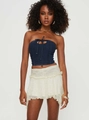 Detail showing high-waisted cream ruffled mini skirt with irregular layered lace hemline - S / Bottoms / White