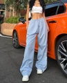 Detail of light blue wide leg track pants featuring white side stripes and elastic waist - Light Blue