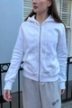 Detail of white zip-up hoodie featuring drawstring hood and smooth cotton fabric - White