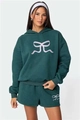 Dettaglio del set felpa con cappuccio verde scuro con stampa fiocco e tessuto pesante - Taglia S / Top E Pantaloni / Verde