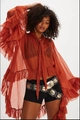 Detail of red-brown sheer ruffle blouse with tie neckline and bohemian style elements - Orange