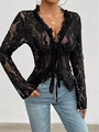 Detail of floral lace texture on a black tie-front crop top with ruffled V-neckline - Black