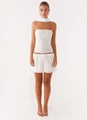 Detail of white two-piece set featuring floral embroidery and ruffled hem skirt - S / Top And Bottom / White