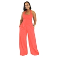 Detail of coral orange halter jumpsuit showing pleated waist and invisible side pockets - Coral