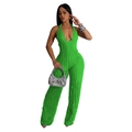 Detail of lime green halter neck jumpsuit showing deep V-neck and pleated fabric texture - S / Green