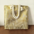 Linen tote bag featuring gold palm leaf pattern and thick white cotton rope handles - Gold Leaves