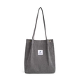 Detail view of corduroy tote bag showing gray ribbed texture and feather label - Dark Gray