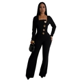 Detail of elegant black long sleeve jumpsuit featuring decorative gold embossed buttons - S / Black