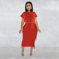 Detail of red two-piece set featuring a short sleeve crop top and fringe midi skirt - S / Red