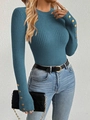 Detail of teal knit sweater cuffs with gold buttons and ribbed texture finish - Blue
