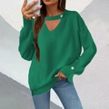 Detail of dark green knit sweater featuring a V-neck cutout and white pearl button accents - Green