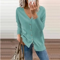 Detail of mint green V-neck knit cardigan featuring button-down front and ribbed cuffs - Lake Green