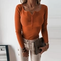 Detail of ribbed knit orange sweater with buttoned V-neck and long sleeves on model - Caramel color / S