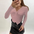 Detail of pink ribbed knit V-neck sweater with front twist and black leather mini skirt - S / Pink