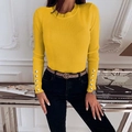 Detailed close-up of ribbed knit texture and gold decorative buttons on the sleeve cuff - Yellow