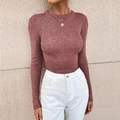 Close-up of women's slim fit dusty pink ribbed knit sweater with a round neck - Brick Red