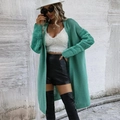 Detailed knit texture of a mint green long cardigan with openwork sleeve patterns - Green
