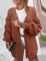 Detail of rust red cable knit cardigan with puff sleeves and textured bubble knit accents - Caramel color