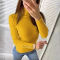 Detail of bright yellow ribbed turtleneck sweater featuring gold decorative sleeve buttons - Yellow