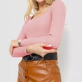 Detailed texture of pink ribbed knit sweater with a deep U-neck and long sleeves - Pink
