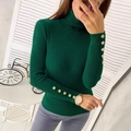 Detailed close-up of dark green turtleneck sweater featuring golden button cuffs - Dark Green