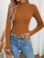 Close-up of caramel ribbed knit sweater featuring decorative buttons on neck and cuffs - Caramel color